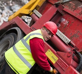 Ian Tyson operating a skip wagon.