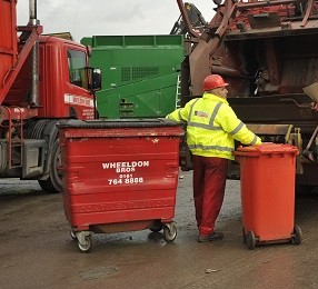 John Wheeldon with two wheelie bins