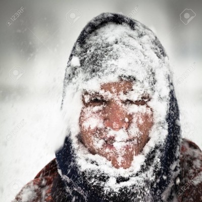 man in a snowstorm outside being more energy efficient